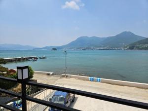a view of a large body of water with mountains at Namhae Soljeong Pension in Namhae