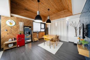 a kitchen and dining room with a table and chairs at Jeju Aromtarom House in Jeju