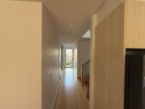 a hallway of a house with white walls and wooden floors at Cowes Central Beach Villa II in Cowes +20 photos