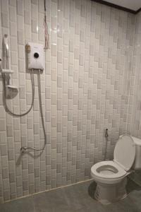 a bathroom with a toilet and a shower stall at Nongsak Riverside Guesthouse & Nongsak Guesthouse in Ban Khon