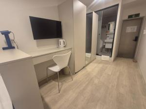a room with a desk with a television and a chair at Seoul On Stay in Seoul