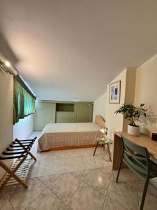 a bedroom with a bed and a table and a desk at Bella Todi Apartment in Todi