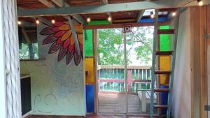 an open door with a flower painted on the wall at Centro Holístico Allpa Samay in Estación El Salto