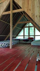 a room with an attic with beds and windows at Centro Holístico Allpa Samay in Estación El Salto