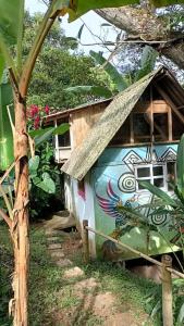 a house with a painting on the side of it at Centro Holístico Allpa Samay in Estación El Salto