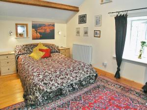 a bedroom with a bed and a window at The Barn in Waberthwaite +5 photos