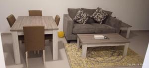 a living room with a couch and a table at Aryaf Hotel Apart Tabasum Group in Ajman 