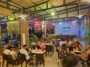 a group of people sitting at tables in a restaurant at Top Views Retreat in Koh Rong Island
