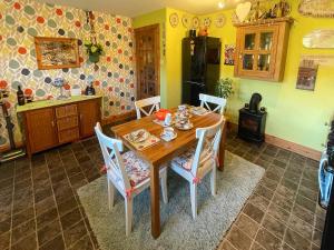 a dining room with a wooden table and chairs at Mystified Bungalow in West Burton +12 photos