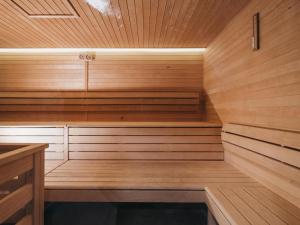 a sauna with wooden walls and wooden floors and ceilings at Hotel Victoriya in Kaprun