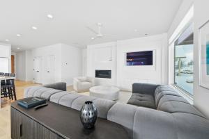 a living room with a large couch and a table at Trappers Ridge Powder Haven in Eden