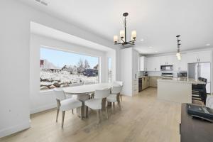 a kitchen and dining room with a table and chairs at Trappers Ridge Powder Haven in Eden +34 photos