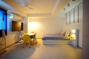 a hotel room with a bed and a table and a tableablish at Unicorn Family Residence Seoul in Seoul
