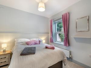 a bedroom with a bed with two towels on it at Stones Throw Cottage in Sheringham +14 photos