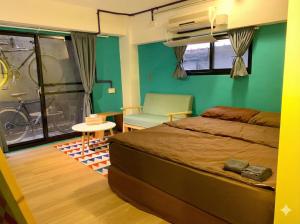 a bedroom with a bed and a chair and a window at 英倫 旅店 in Tainan +14 photos