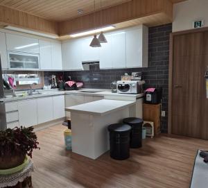a kitchen with white cabinets and a counter top at Hwacheon Ujune Minbak in Hwach'ŏn