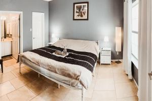 a bedroom with a bed with a black and white blanket at Stylish Island Villa on Lake Travis in Lago Vista