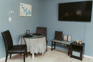 a living room with a table and chairs and a tv at Stylish Island Villa on Lake Travis in Lago Vista