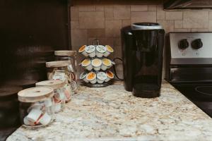 a kitchen counter with cups and a blender on it at Stylish Island Villa on Lake Travis in Lago Vista