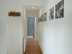 a hallway with pictures on the walls of a house at No2 The Neuk in Belford
