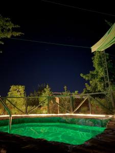 a swimming pool at night with a fence at Termas Del Vino 2 in Palmilla Abajo +3 photos