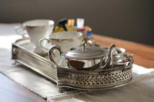 a silver tray with two cups on a table at The Kingsman boutique Hotel in Burgersdorp +36 photos