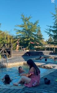 a group of people swimming in a swimming pool at Termas del Vino 3 in Palmilla Abajo