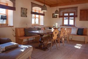 a living room with a wooden table and chairs at Haus am Salinenweg in Grassau
