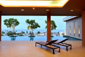 a patio with chairs and a view of the water at Hisea Huahin Hotel in Hua Hin