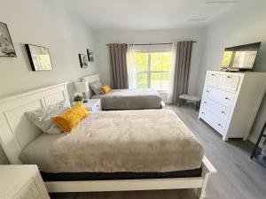 a bedroom with two twin beds and a dresser at Spacious 2BR Lely Resort Condo with Lake View steps to Pool Hot Tub Gym in Naples +62 photos