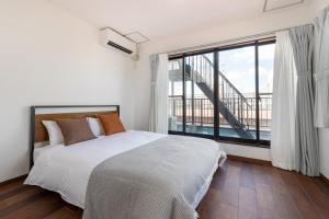 a bedroom with a large bed and a large window at -Numabukuro House- 10-minute walk from Numabukuro station in Tokyo +38 photos