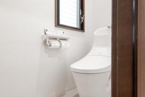 a bathroom with a white toilet and a mirror at -Numabukuro House- 10-minute walk from Numabukuro station in Tokyo