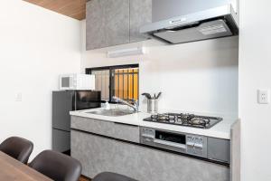 a kitchen with a sink and a stove at -Numabukuro House- 10-minute walk from Numabukuro station in Tokyo