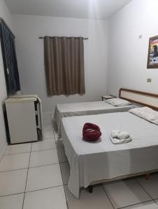 a room with two beds and a mirror in it at Hotel Internacional in Cianorte +31 photos