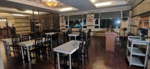 a dining room with tables and chairs in a restaurant at Townhouse Oak Vera Hotel Near Clark International Airport in Angeles