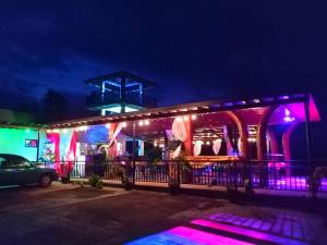 a building with colorful lights on it at night at Buxton Gan Resort Hotel in San Andres +131 photos