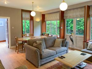 a living room with a couch and a table at The Coyles - Uk31466 in Ballater