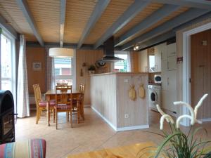a kitchen and dining room with a table and chairs at Marinapark Scharmützelsee in Wendisch Rietz