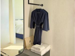 a mirror on a wall with a robe and towels at MITI TIKAAN villa in Ban Muang Chum +53 photos