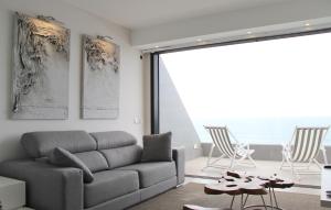 a living room with a couch and a table and chairs at Penthouse Over The Sea in Las Palmas de Gran Canaria