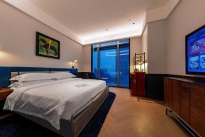 a bedroom with a bed and a flat screen tv at The Protons Guangzhou in Guangzhou +120 photos
