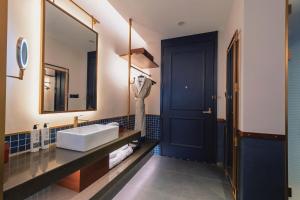 a bathroom with a sink and a mirror at The Protons Guangzhou in Guangzhou