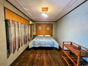 a bedroom with a bed and a wooden floor at The Florist Ayutthaya in Phra Nakhon Si Ayutthaya