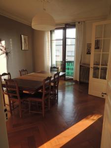 a dining room with a table and chairs at Le grand Charpentier in Mulhouse