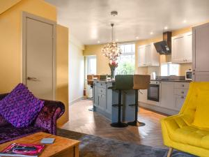 a kitchen with two chairs and a table in a room at Hollingreave House in Burnley
