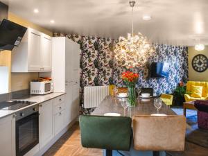 a kitchen and dining room with a table and chairs at Hollingreave House in Burnley