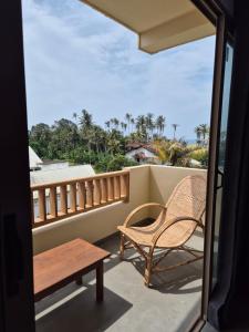 a balcony with a chair and a bench on it at Sky Bloom Ahangama in Ahangama