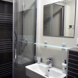 a bathroom with a sink and a shower with a mirror at Haus Vinzenz in Obertauern