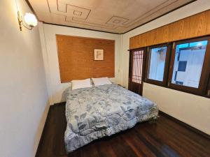 a bedroom with a bed with a wooden headboard at The Florist Ayutthaya in Phra Nakhon Si Ayutthaya