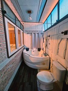 a bathroom with a tub and a toilet and a sink at The Florist Ayutthaya in Phra Nakhon Si Ayutthaya +15 photos